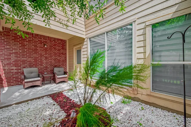 a view of a patio with table and chairs and potted plants