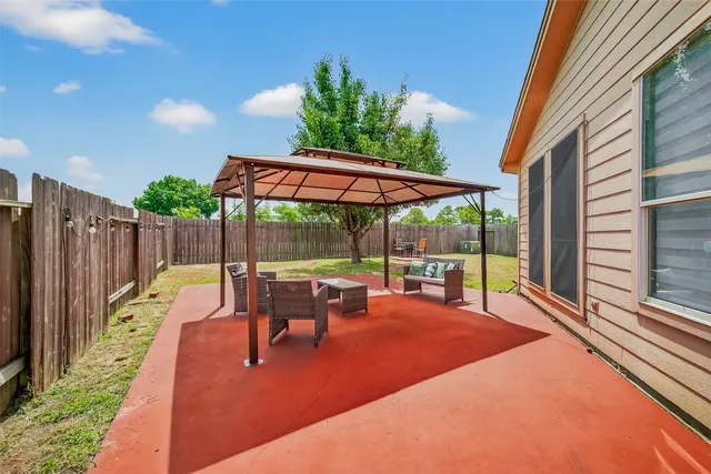 a view of an outdoor sitting area with wooden fence