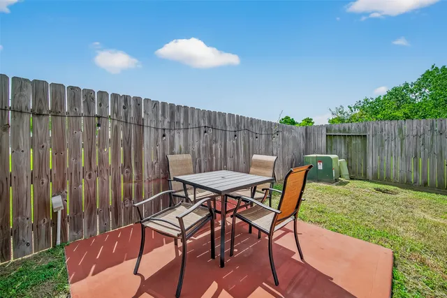 a view of a chairs and table in the patio