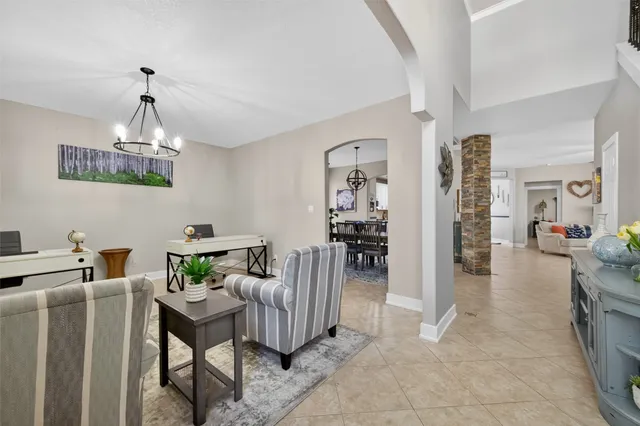 a dining room with furniture and chandelier