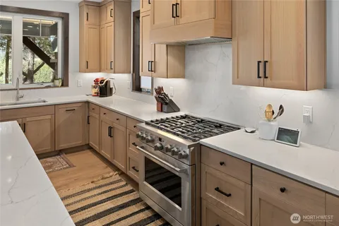 a kitchen with a stove and white cabinets