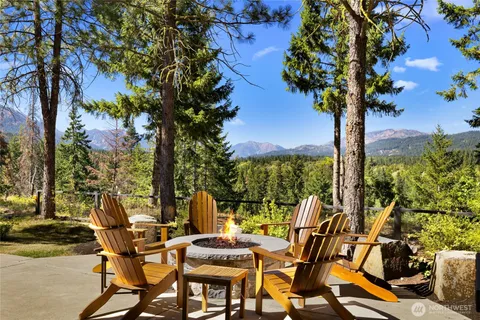 a view of a patio with table and chairs and potted plants