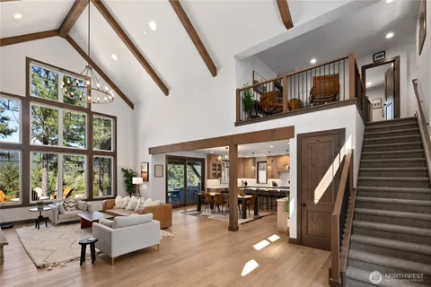 a living room with furniture and large windows