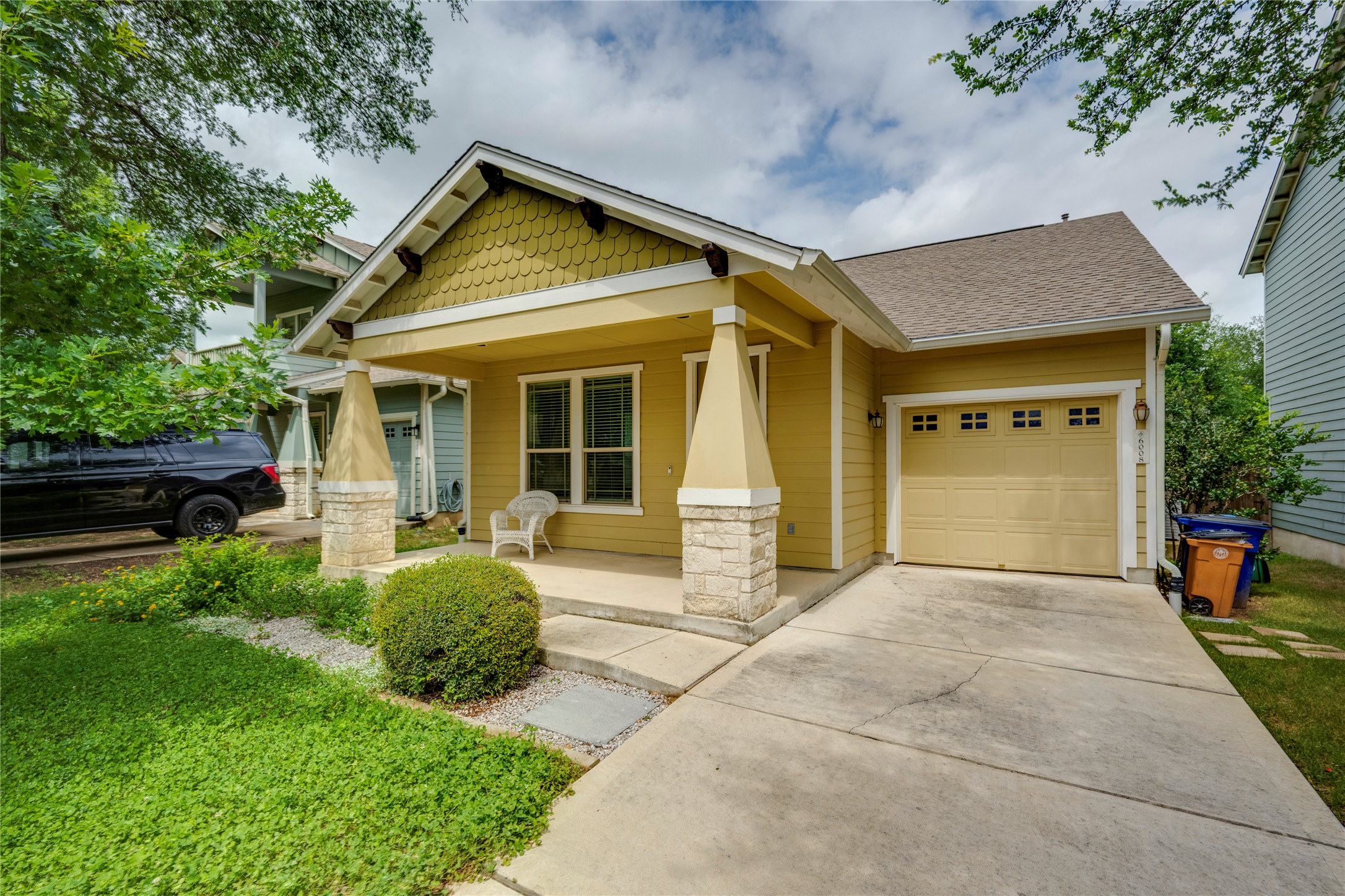 6008 Whipple Way Austin, TX 78745 - Photo 1 of 39 A welcoming facade showcases a covered front porch and an integrated garage with a concrete driveway.