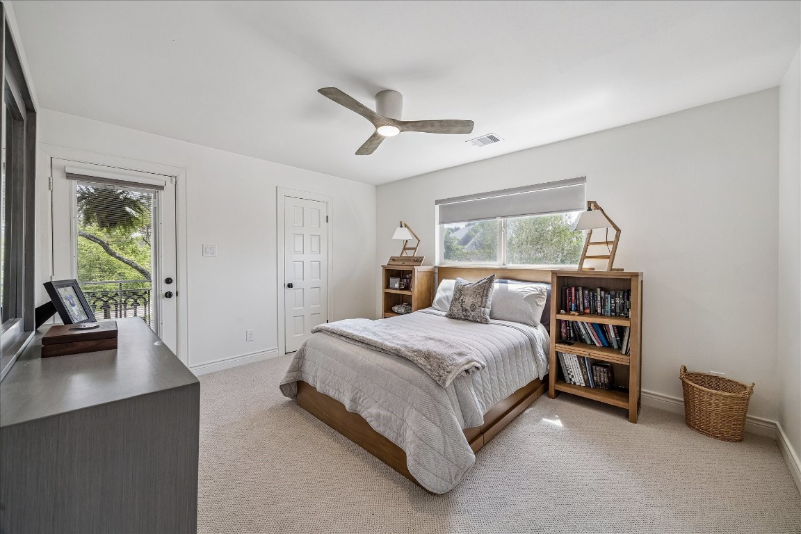 627 Ramblewood Road Houston, TX 77079 - Photo 25 of 48 Secondary bedroom with balcony access, new paint, carpet and ceiling fan.