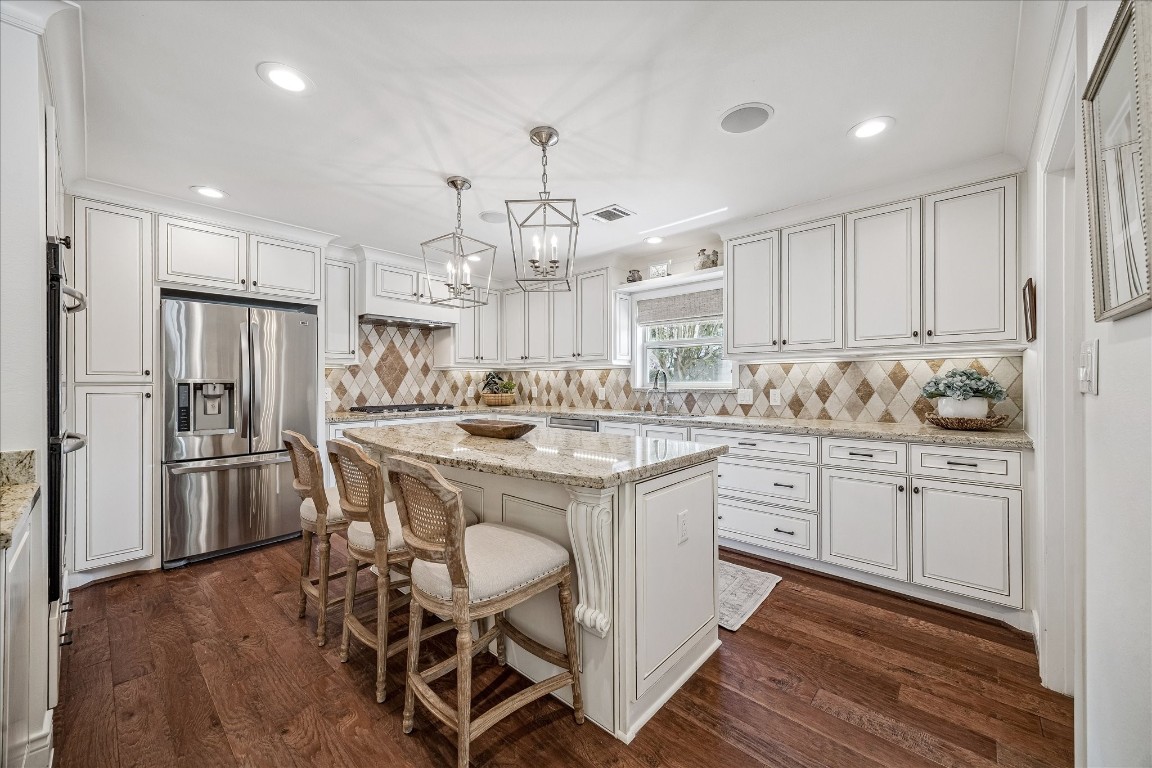 627 Ramblewood Road Houston, TX 77079 - Photo 4 of 48 Cheerful light and bright kitchen with island, lots of counter space, large walk in pantry, custom spice rack and soft close drawers.