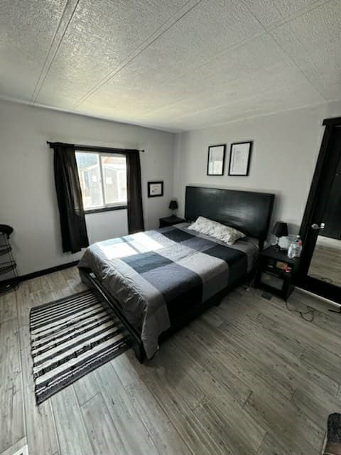 657 Lebec Road, Unit 27 Lebec, CA 93243 - Photo 4 of 6 a bedroom with a bed and wooden floor
