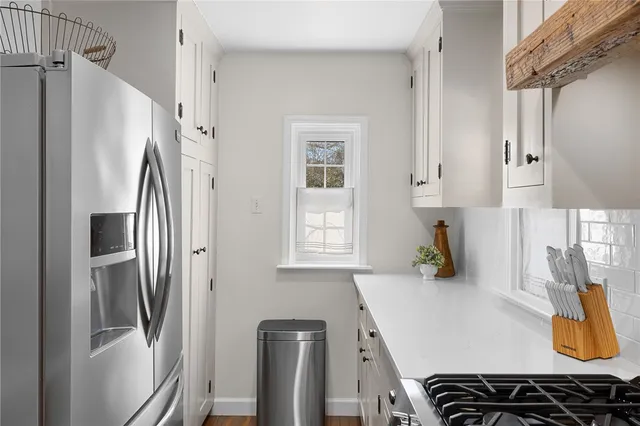 a kitchen with stainless steel appliances a sink stove and refrigerator