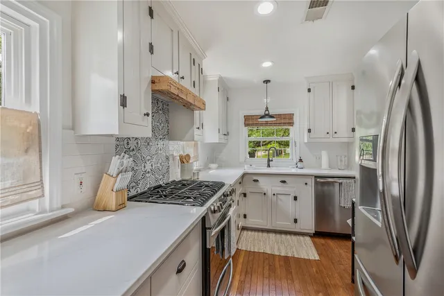 a kitchen with stainless steel appliances granite countertop a stove and a sink