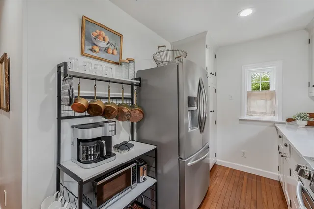a kitchen with granite countertop a sink and white cabinets