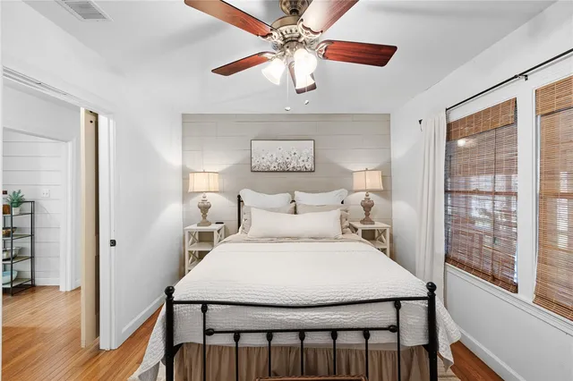 a bedroom with a bed and a painting on the wall