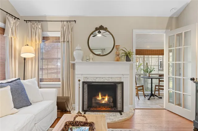 a living room with furniture a window and a fireplace