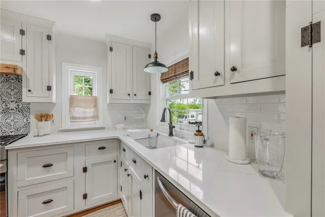 a kitchen with a white stove and white cabinets