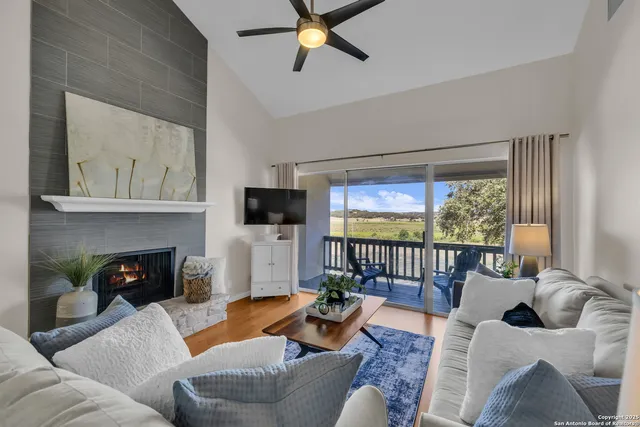 a living room with furniture a fireplace and a flat screen tv