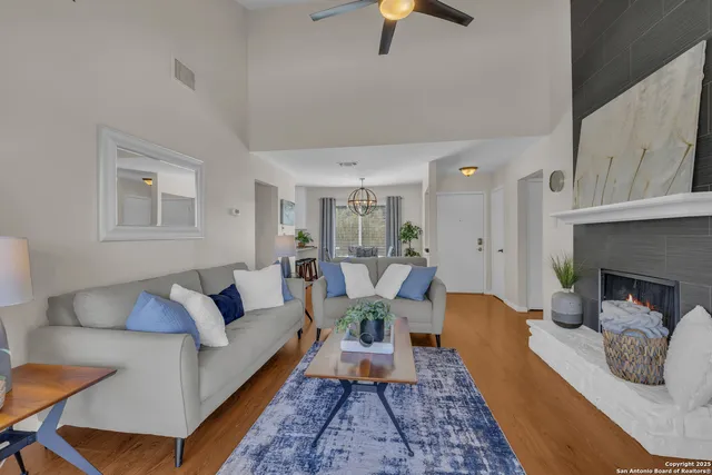 a living room with furniture and a fireplace