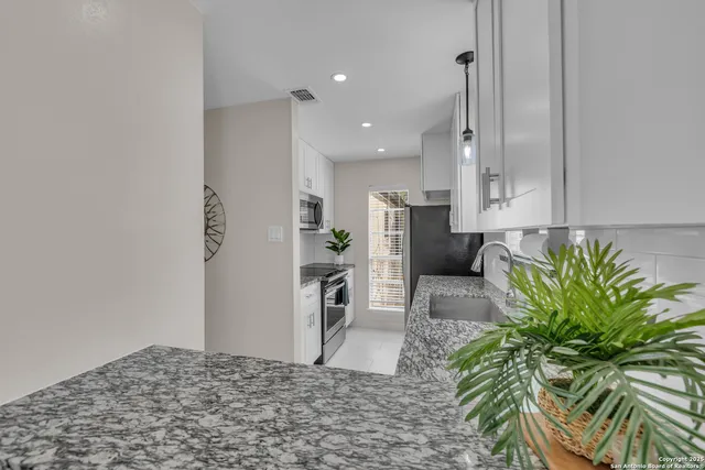 a view of a kitchen with refrigerator and trees