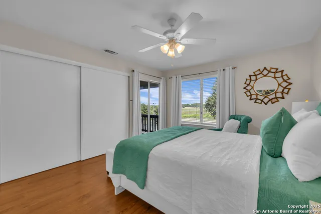 a bedroom with a large bed and a window