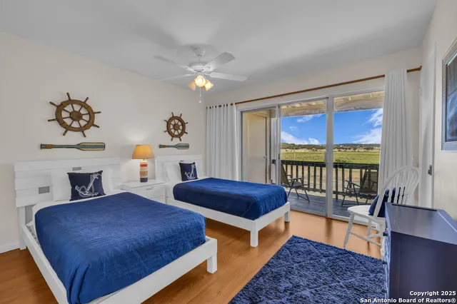 a bedroom with 2 bed and a window