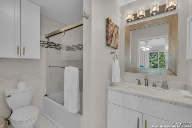 a bathroom with a toilet sink and shower