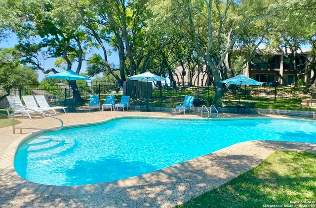 a view of a swimming pool with a patio
