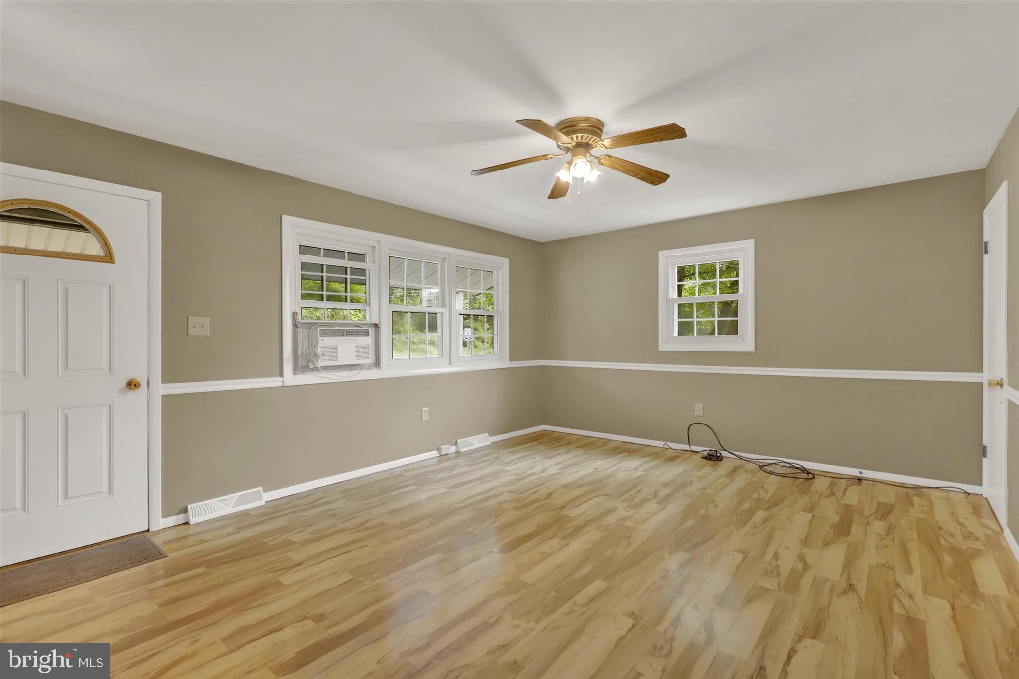 2441 River Road Middletown, PA 17057 - Photo 2 of 20 a view of an empty room with a window and wooden floor