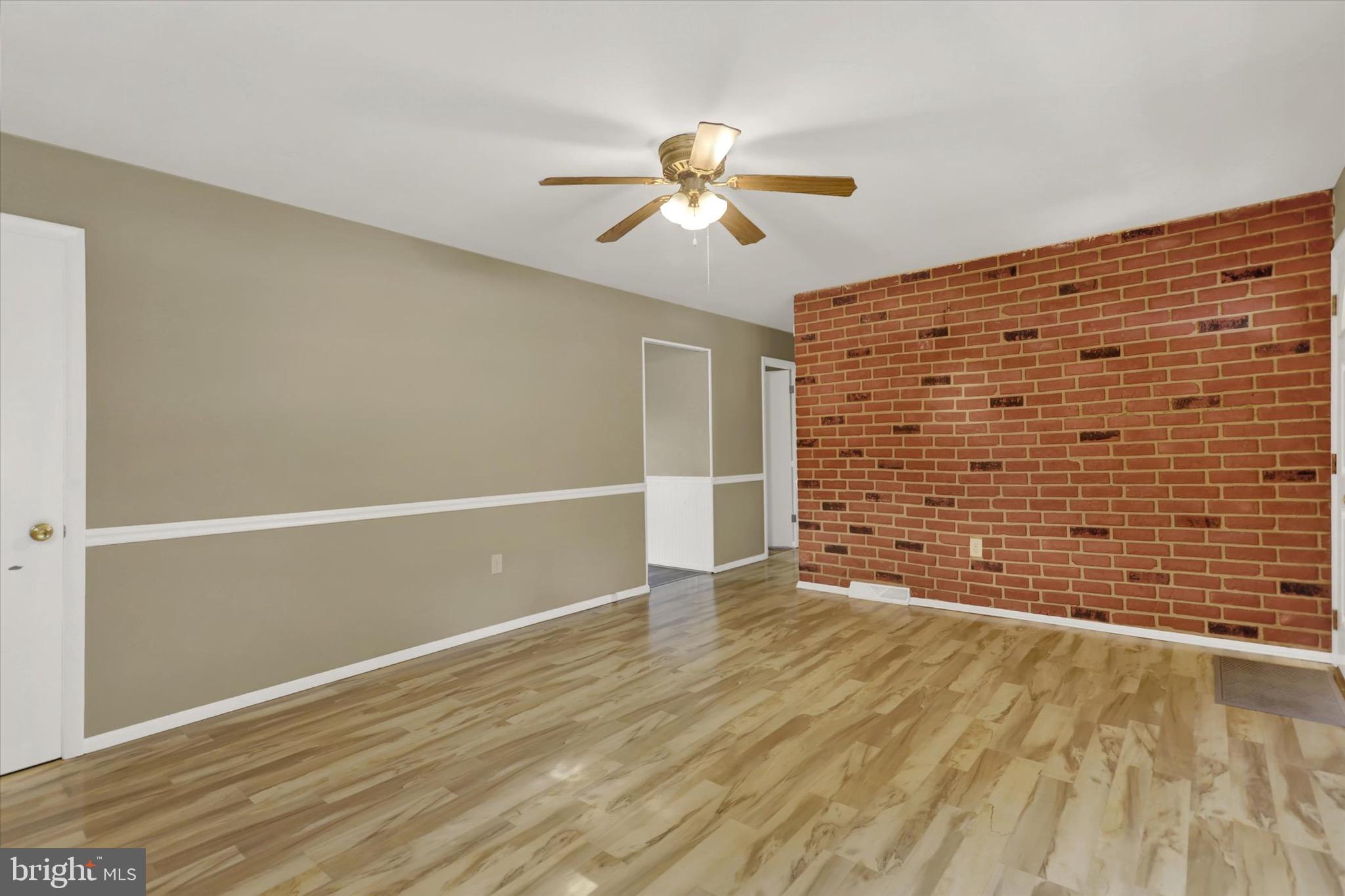2441 River Road Middletown, PA 17057 - Photo 3 of 20 a view of an empty room with wooden floor and a ceiling fan
