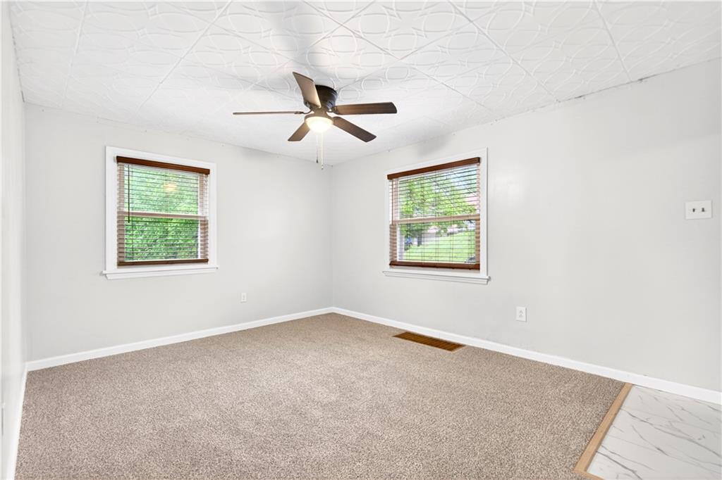 124 Bunker Hill Road Aliquippa, PA 15001 - Photo 13 of 37 an empty room with windows and fan