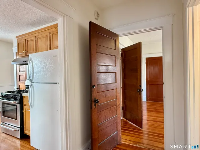 a view of kitchen with stainless steel appliances cabinets and a window