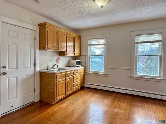 a kitchen with sink cabinets and wooden floor