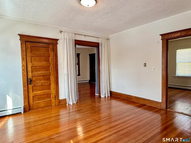 wooden floor in an empty room with a window