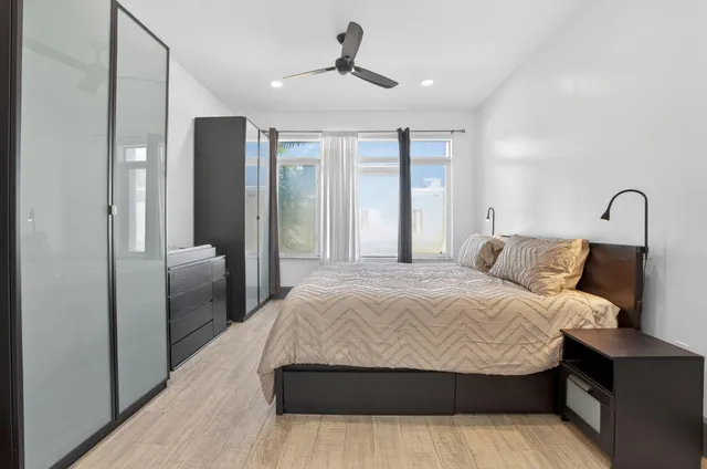 a bedroom with a large bed and a chandelier