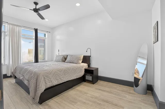 a bedroom with a bed and wooden floor