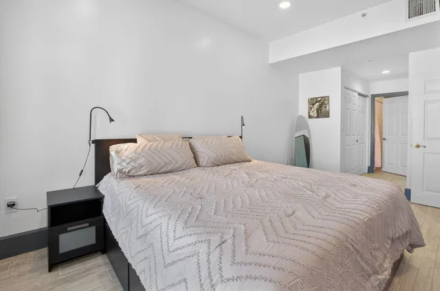 a bedroom with a bed and a lamp