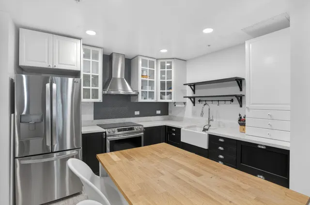a kitchen with a refrigerator and a sink