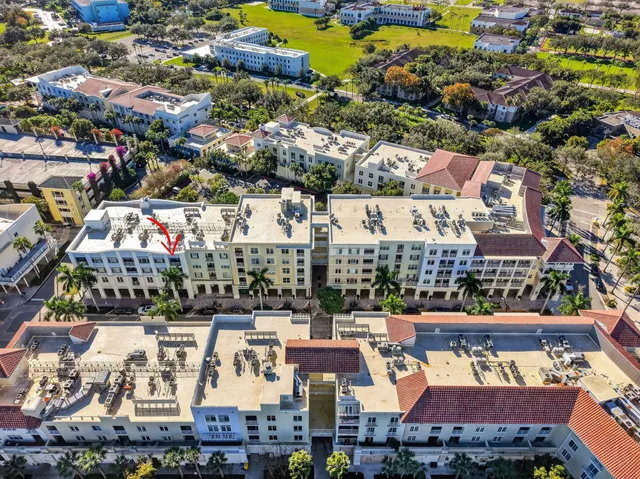 a view of a fountain in front of a house with a big yard