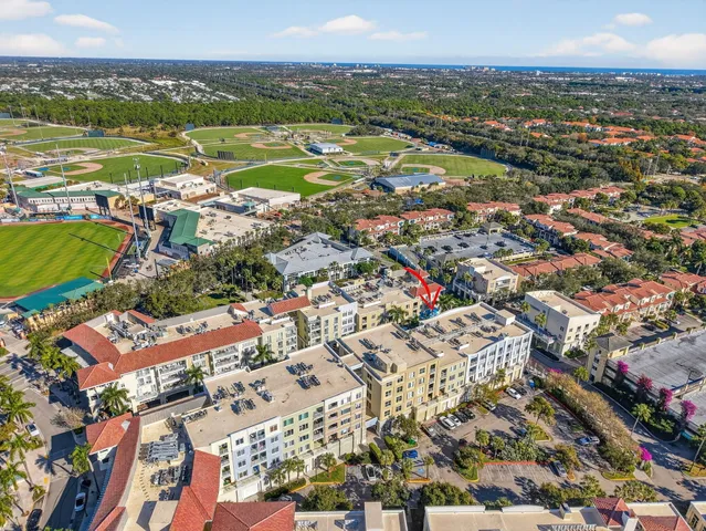 an aerial view of a house with a garden and lake view