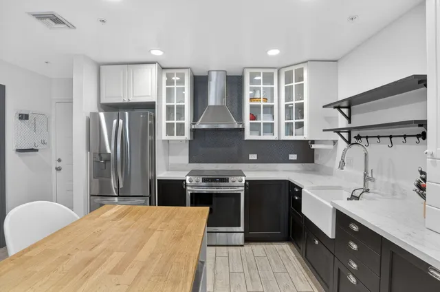 a kitchen with a sink stove and refrigerator