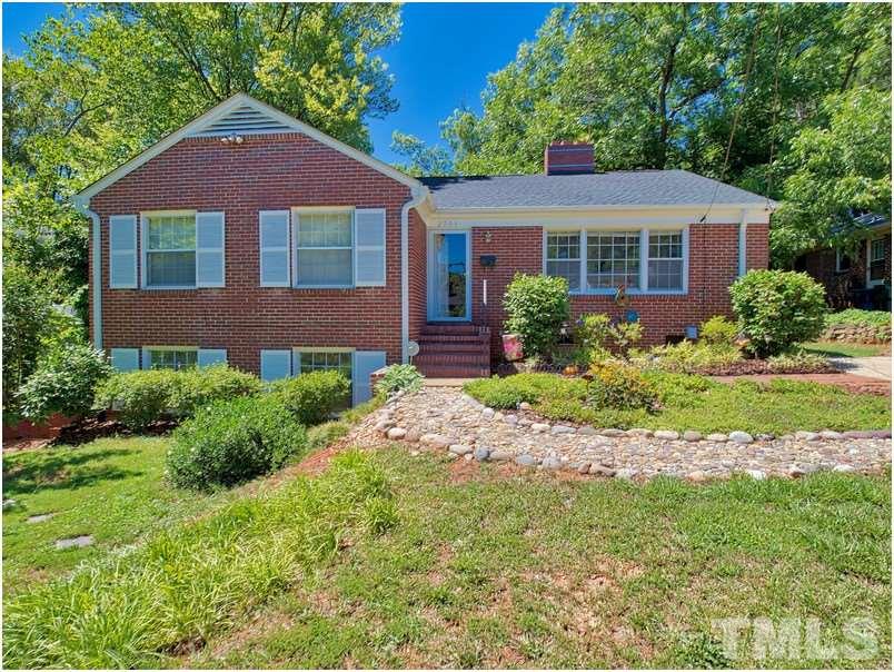 2703 Clark Avenue Raleigh, NC 27607 - Photo 2 of 24 a front view of a house with a yard and potted plants