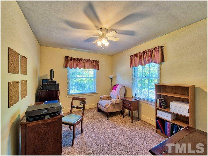 2703 Clark Avenue Raleigh, NC 27607 - Photo 12 of 24 a living room with furniture a piano and a flat screen tv
