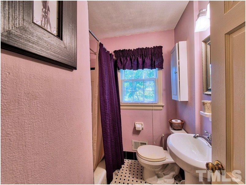 2703 Clark Avenue Raleigh, NC 27607 - Photo 13 of 24 a white toilet sitting next to a bathroom sink