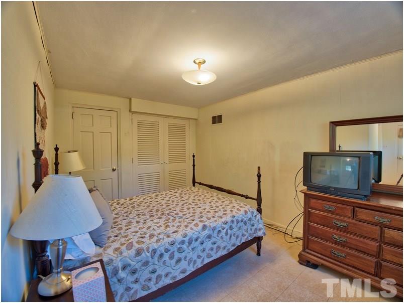 2703 Clark Avenue Raleigh, NC 27607 - Photo 16 of 24 a bedroom with a bed and a flat screen television