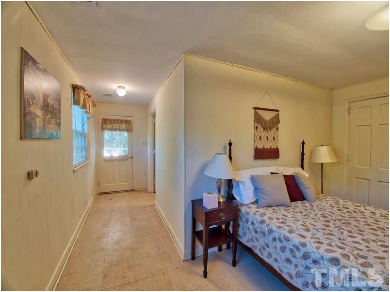 2703 Clark Avenue Raleigh, NC 27607 - Photo 17 of 24 a bedroom with a bed and a painting on the wall