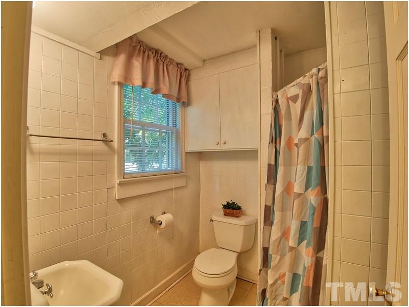 2703 Clark Avenue Raleigh, NC 27607 - Photo 18 of 24 a bathroom with a toilet and a shower