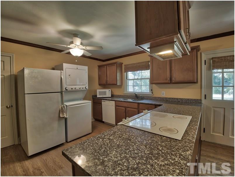2703 Clark Avenue Raleigh, NC 27607 - Photo 8 of 24 a kitchen with stainless steel appliances granite countertop a refrigerator a stove a sink dishwasher and a refrigerator with wooden floor