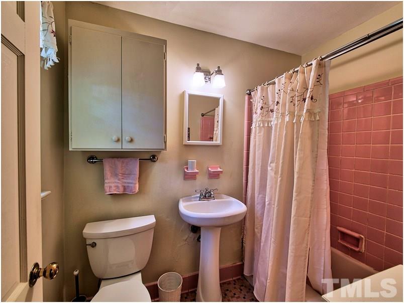 2703 Clark Avenue Raleigh, NC 27607 - Photo 10 of 24 a bathroom with a sink toilet and shower