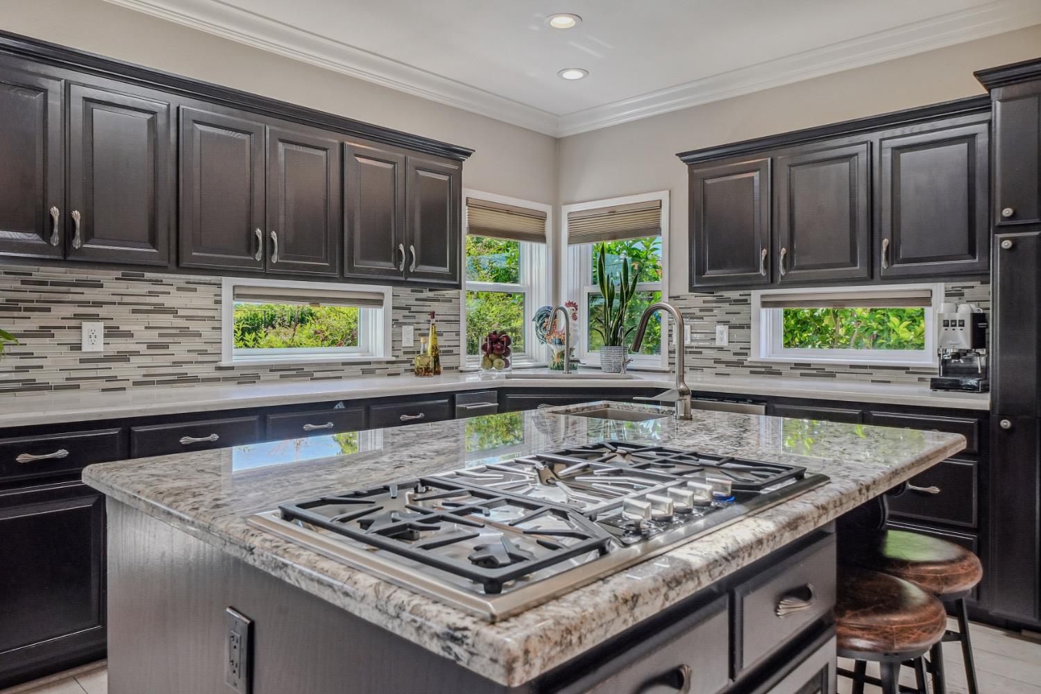 10786 Shenandoah Road Plymouth, CA 95669 - Photo 17 of 80 a kitchen with a stove a sink dishwasher and cabinets with wooden floor