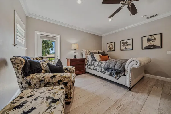 a bedroom with a bed and a potted plant