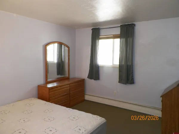 a bedroom with a bed and a dresser