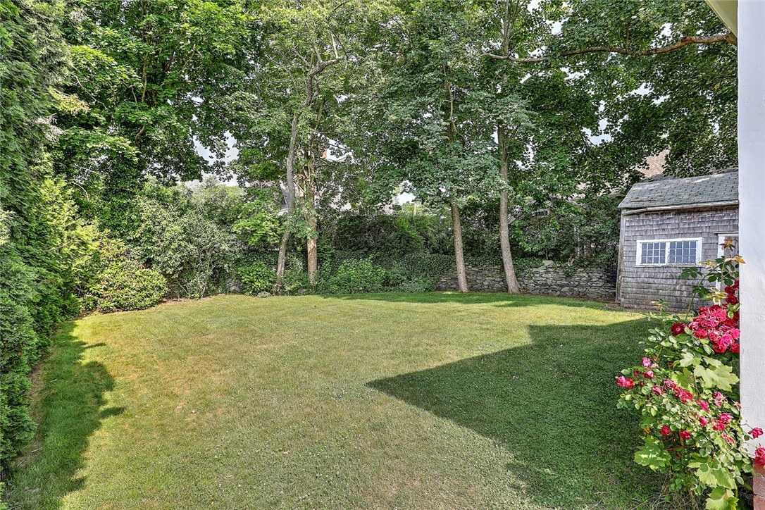 833 Main Street Warren, RI 02885 - Photo 6 of 47 Back yard and side yard by the old shed has a charming tall stonewall