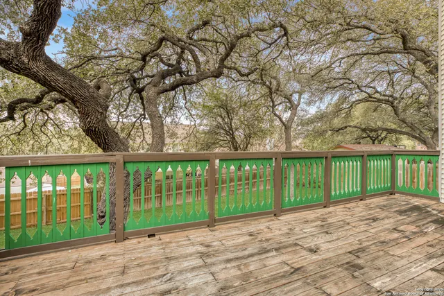 a view of a house with a yard and large trees